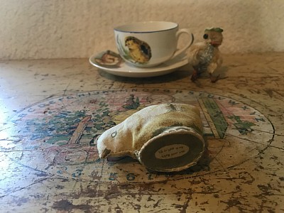 4 chicks! A darling 2” cotton stuffed pecking chick. Home sewn carded and dated on bottom October 4, 1892.  Antique Porcelain cup and saucer with chick images and chenille chick with wire feet and terra cotta beak. ~ $ 99